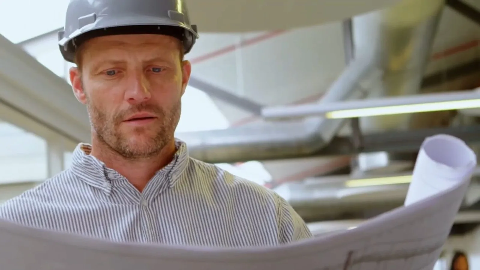 Plumbing contractor reviewing plans before a service or remodel project