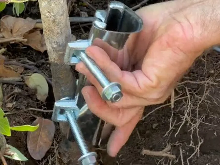 Underground water service line fitting being repaired near landscaping